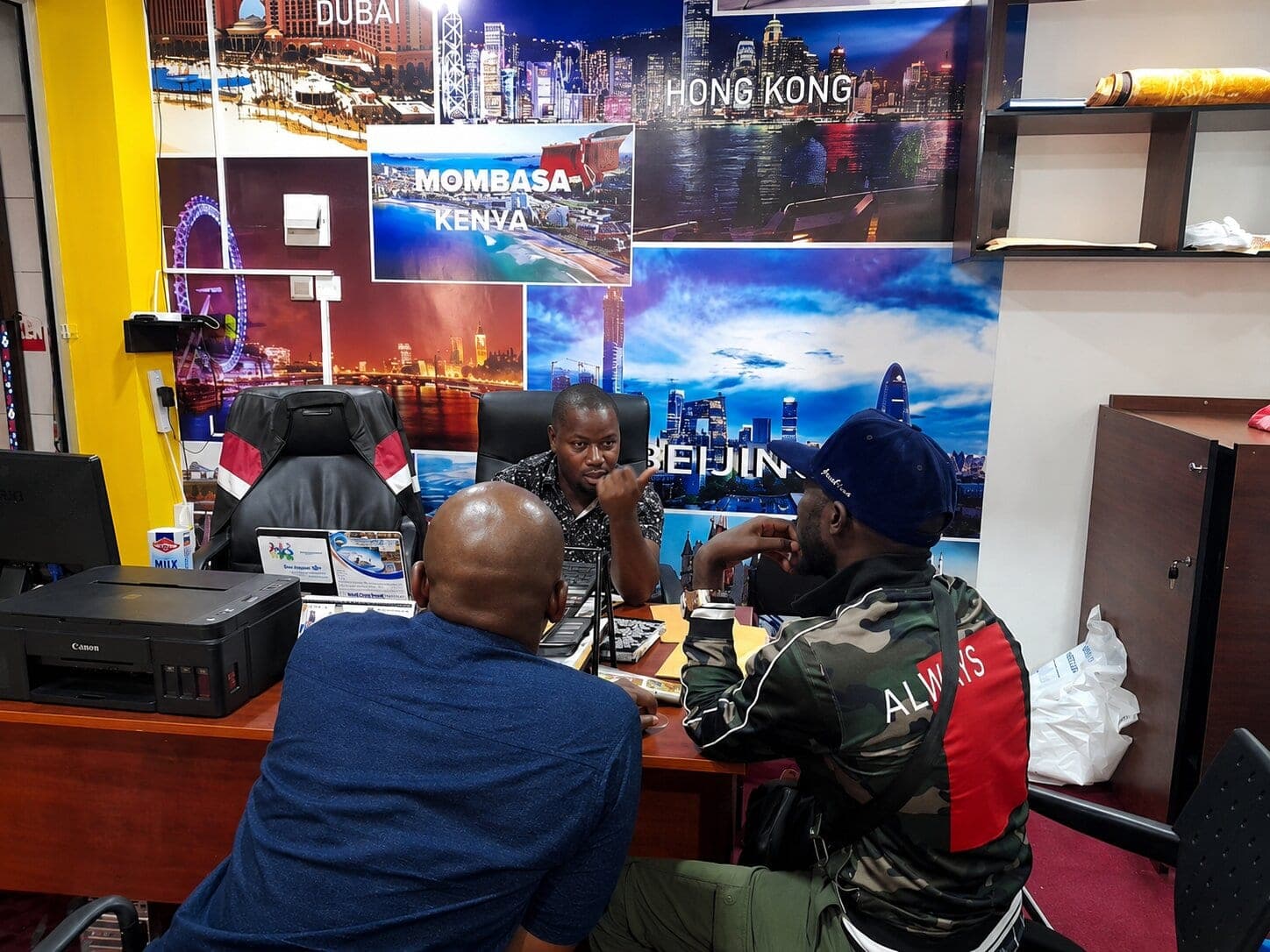 Ssenyonga Isaac, CEO of Shamo Tours & Travel, meeting with clients at the office